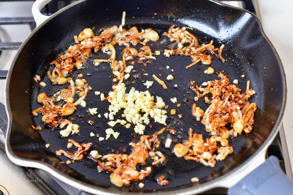 sautéed mushrooms in the pan with garlic added
