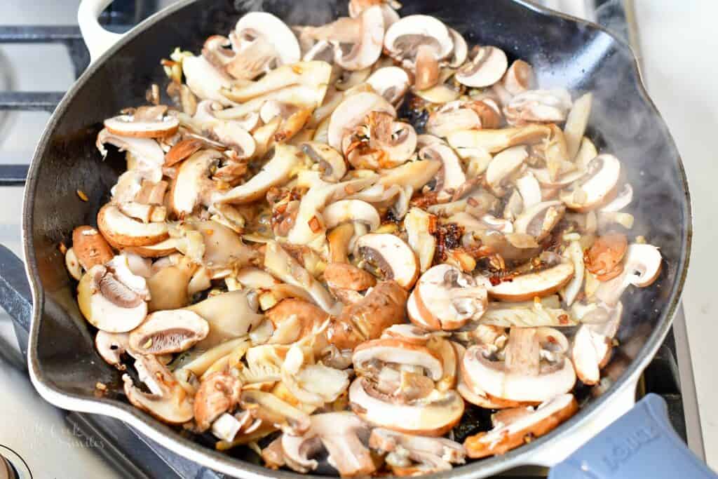mushrooms cooking in the pan with onions and garlic