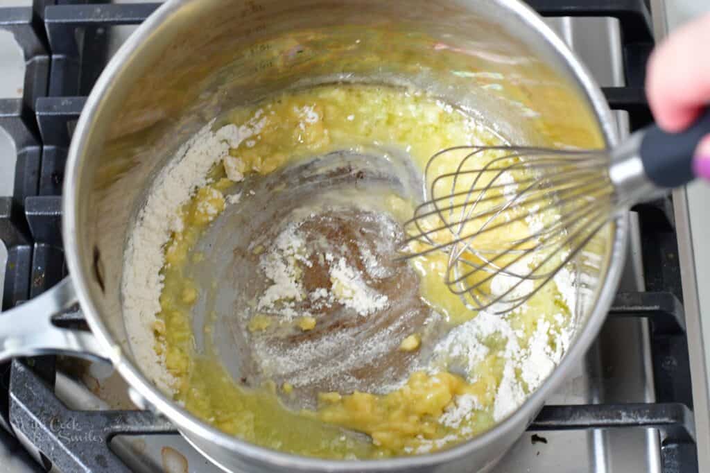 whisking flour with butter in a pot