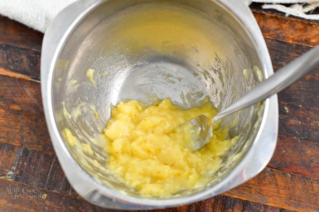 mashing banana in a small mixing bowl