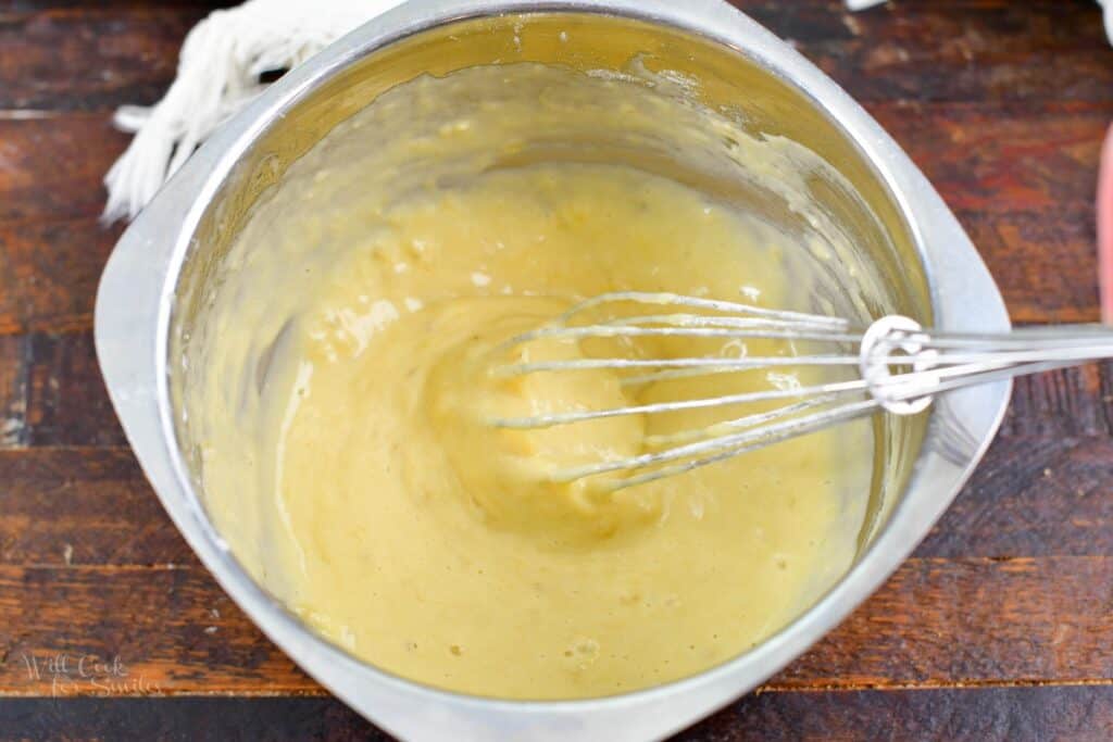 whisking batter in a small mixing bowl