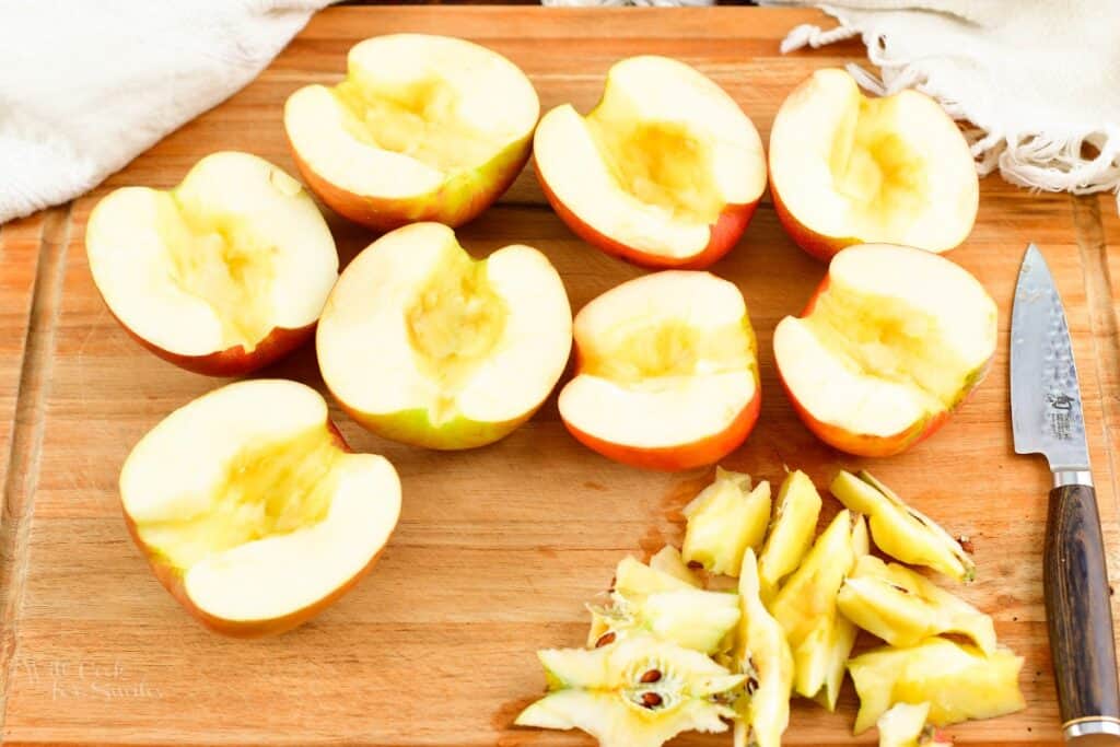 halved and cored apples on the cutting board