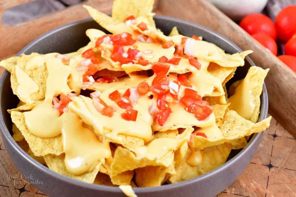 closeup of nachos with cheese and pico in a bowl