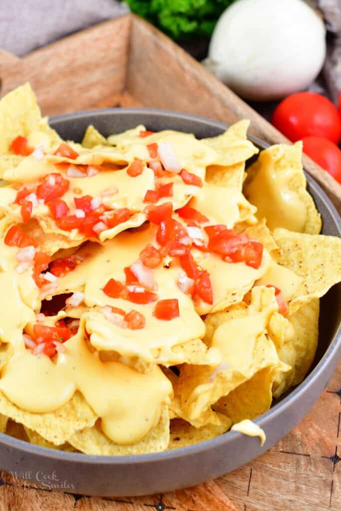 nachos with pico and nacho cheese in a bowl