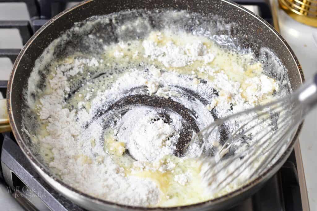 mixing in flour with butter in a pan