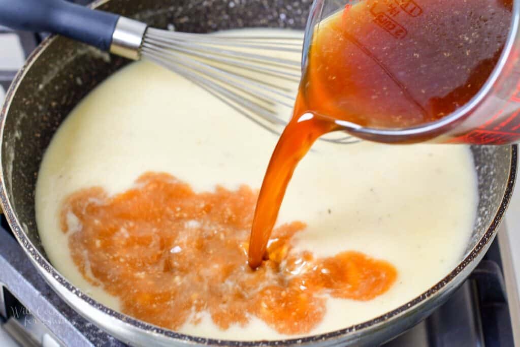 adding beef stock to the gravy