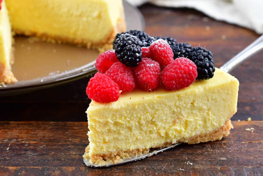 closeup of a slice of ricotta cheesecake with berries