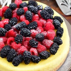top view of a whole ricotta cheesecake topped with berries