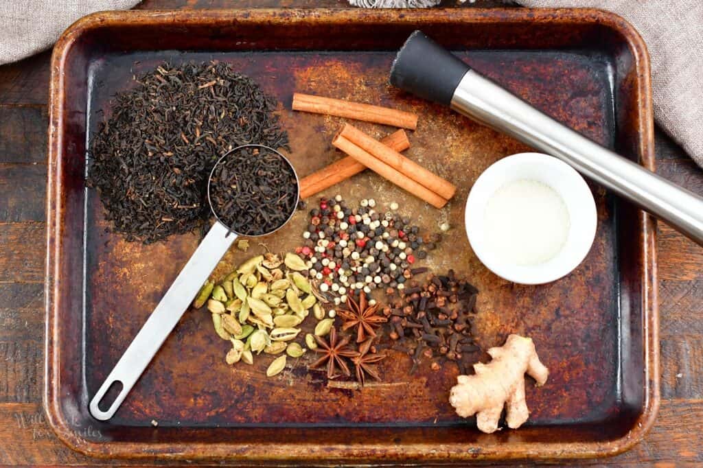 ingredients to make chai latte on the baking sheet