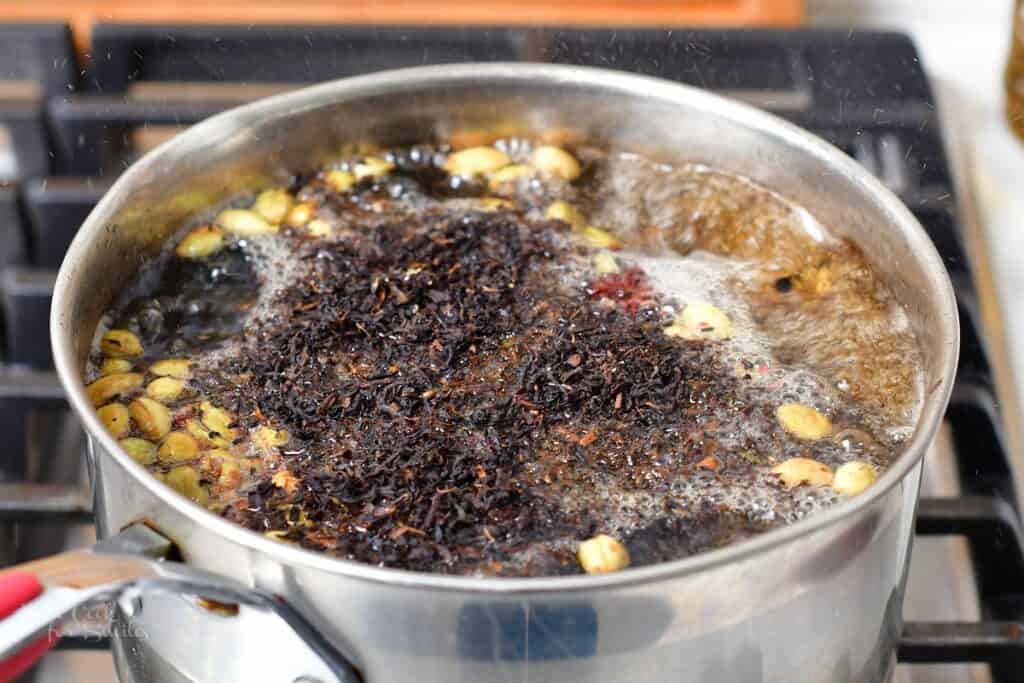 boiling water with spices and added loose leaf tea