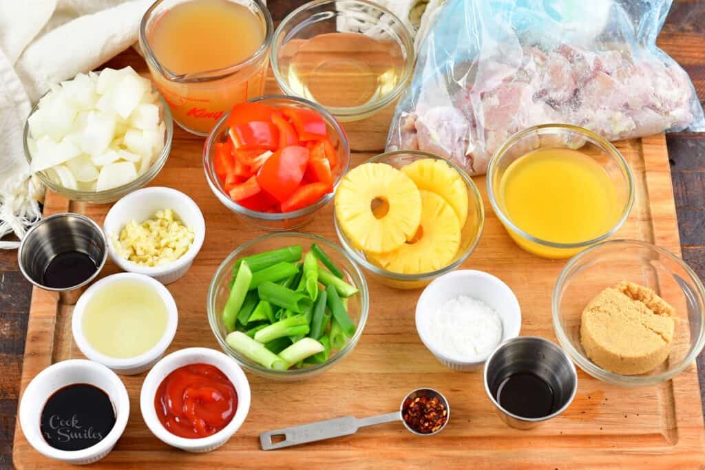 ingredients for sweet and sour chicken on a board