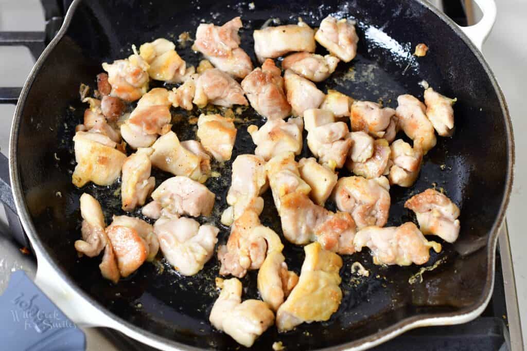 searing chicken pieces in a skillet