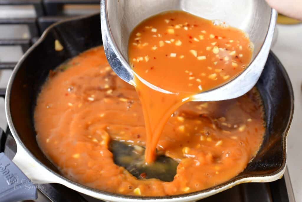 adding sauce into the hot skillet