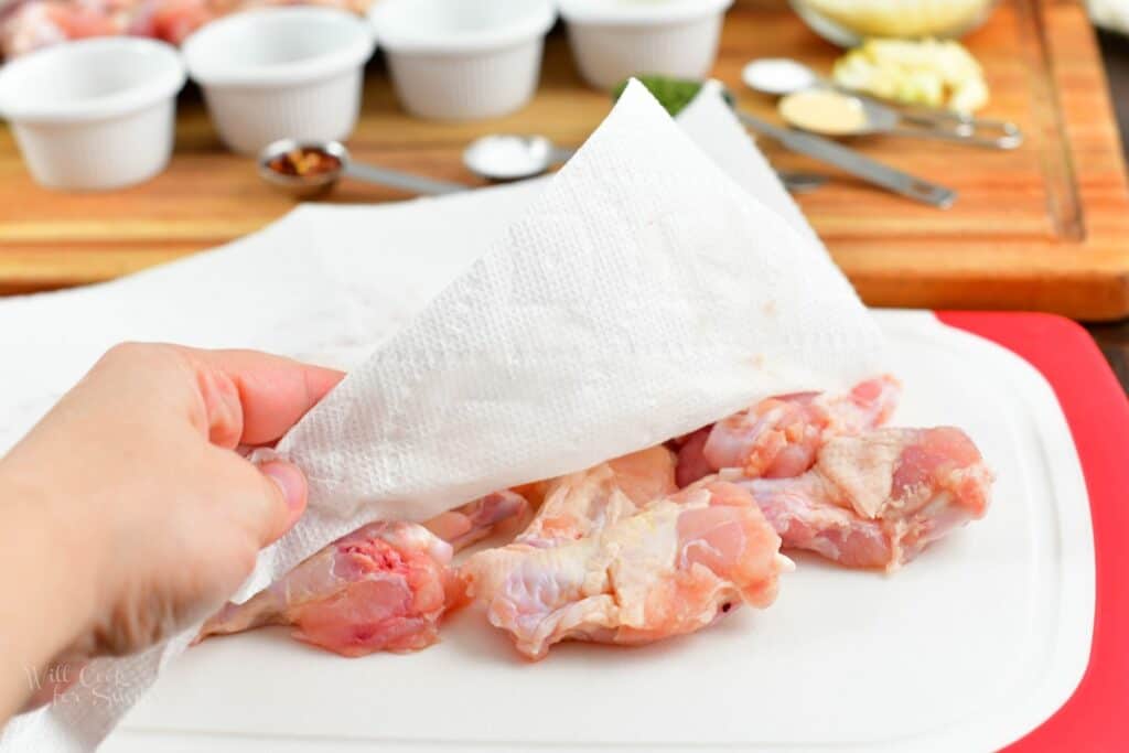 patting the chicken wings with paper towels