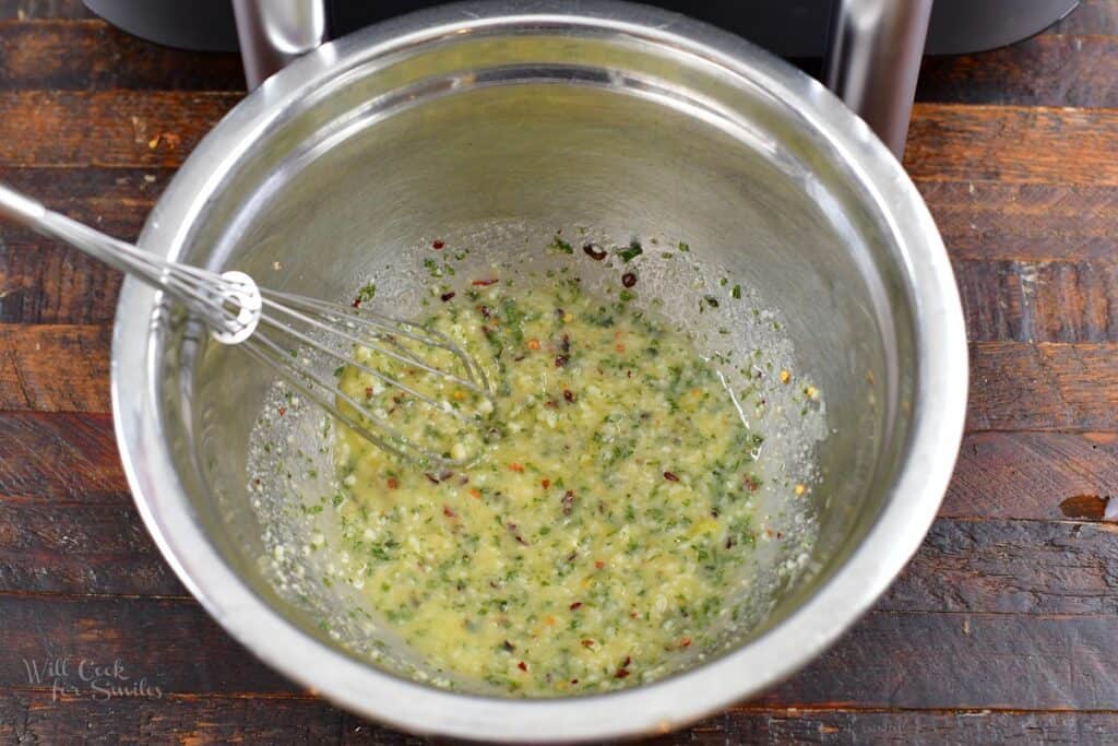 garlic parmesan sauce whisked in a mixing bowl