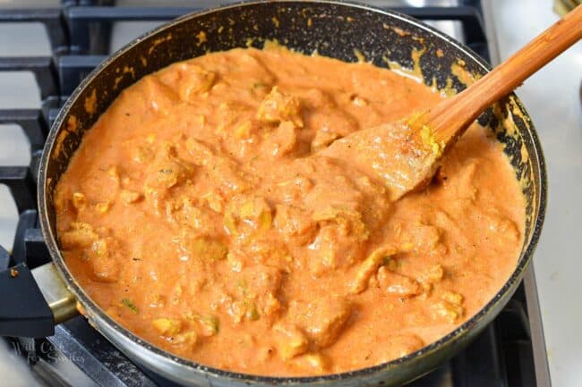 finished cooked butter chicken in sauce in a cooking pan