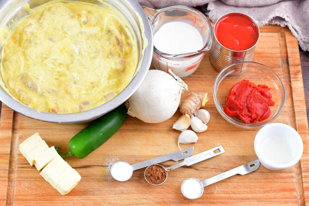 ingredients for butter chicken on a cutting board