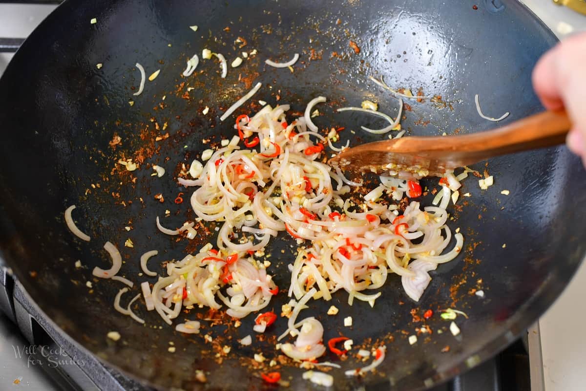 searing shallots with chilis ginger and garlic