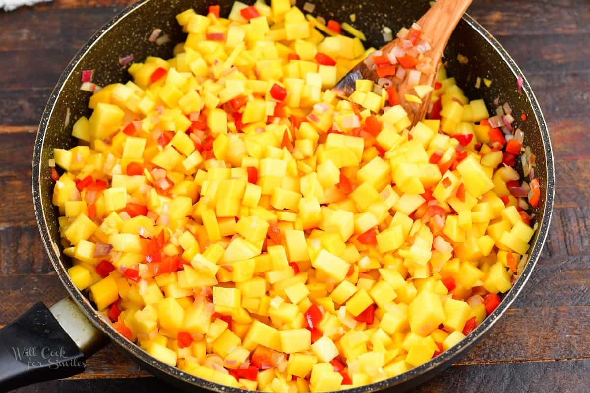 mango, onions, and peppers in a pan