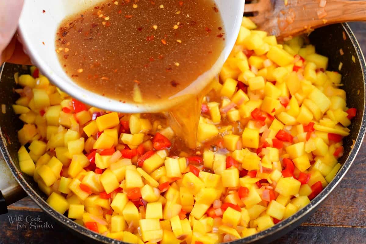 adding liquids to the mango and peppers