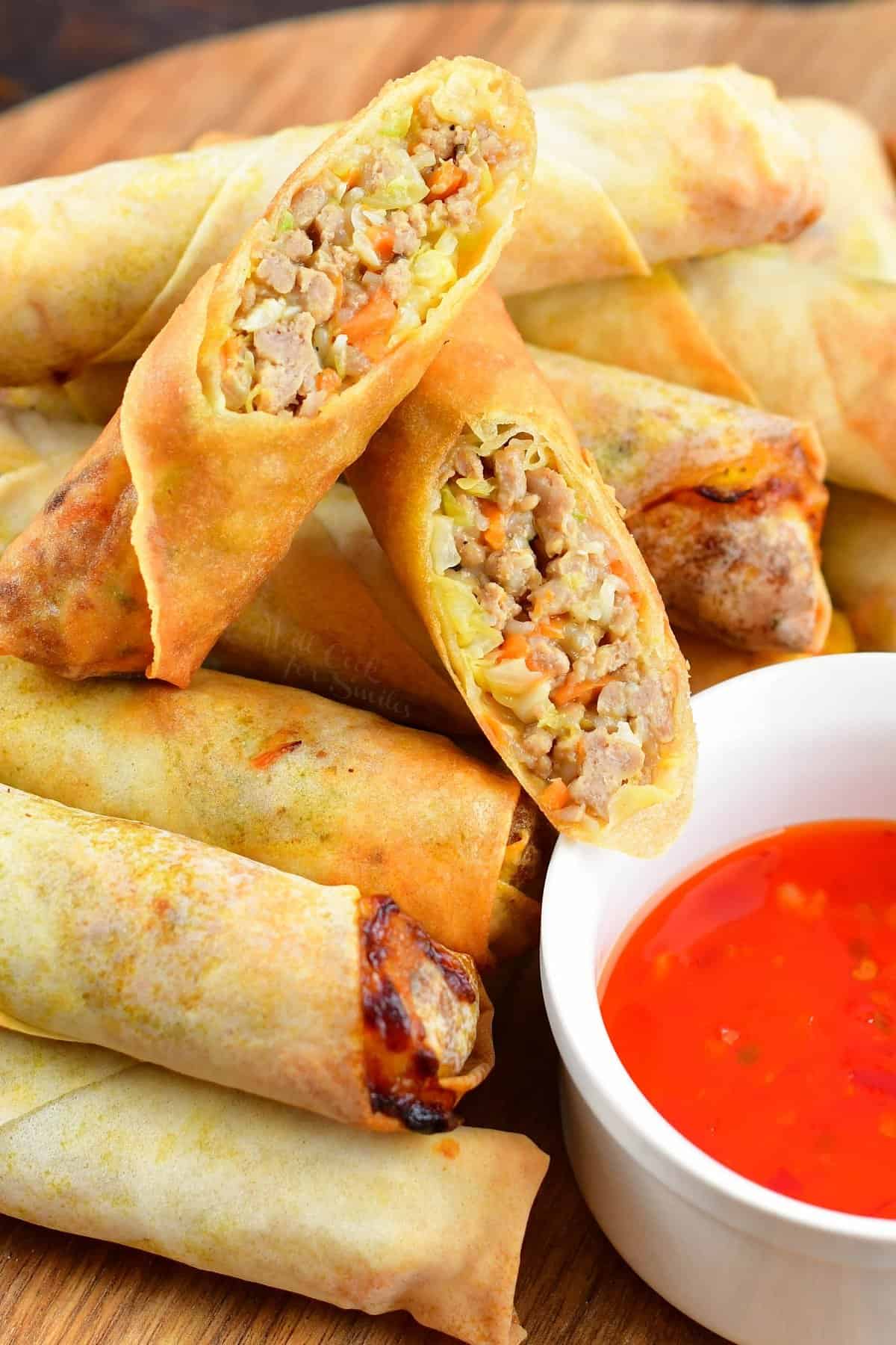 two halves of Thai spring roll cut in half stacked on top of more spring rolls.