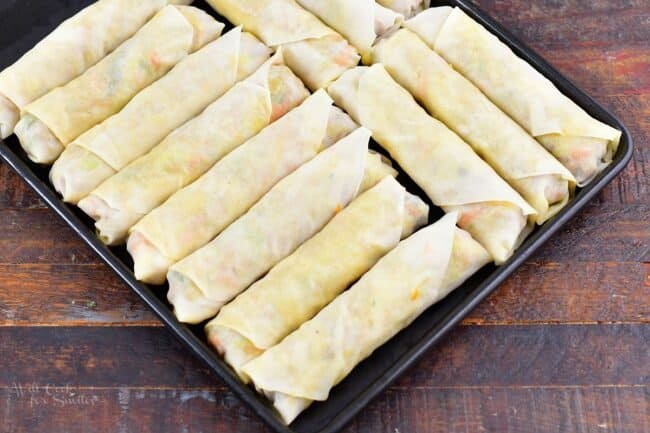 rolled Thai spring rolls on a baking sheet