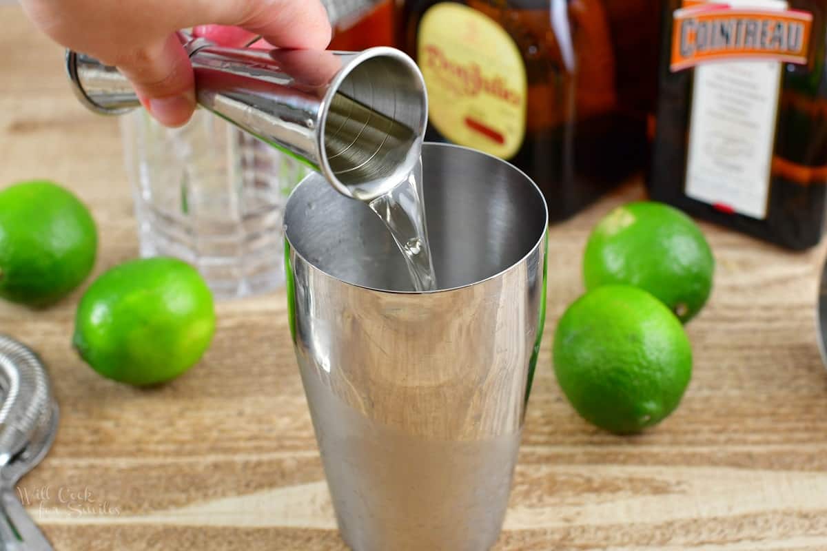 pouring in tequila into the cocktail shaker