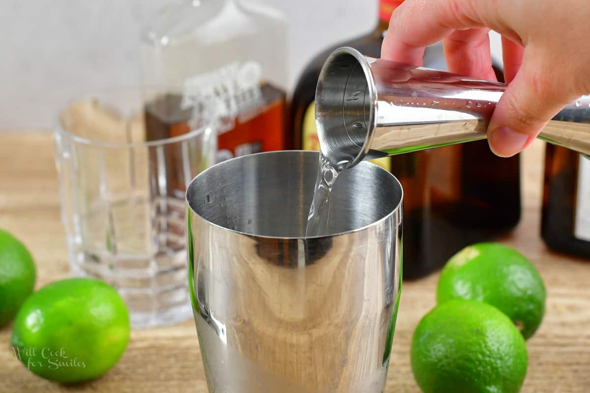 pouting the orange liqueur into the shaker