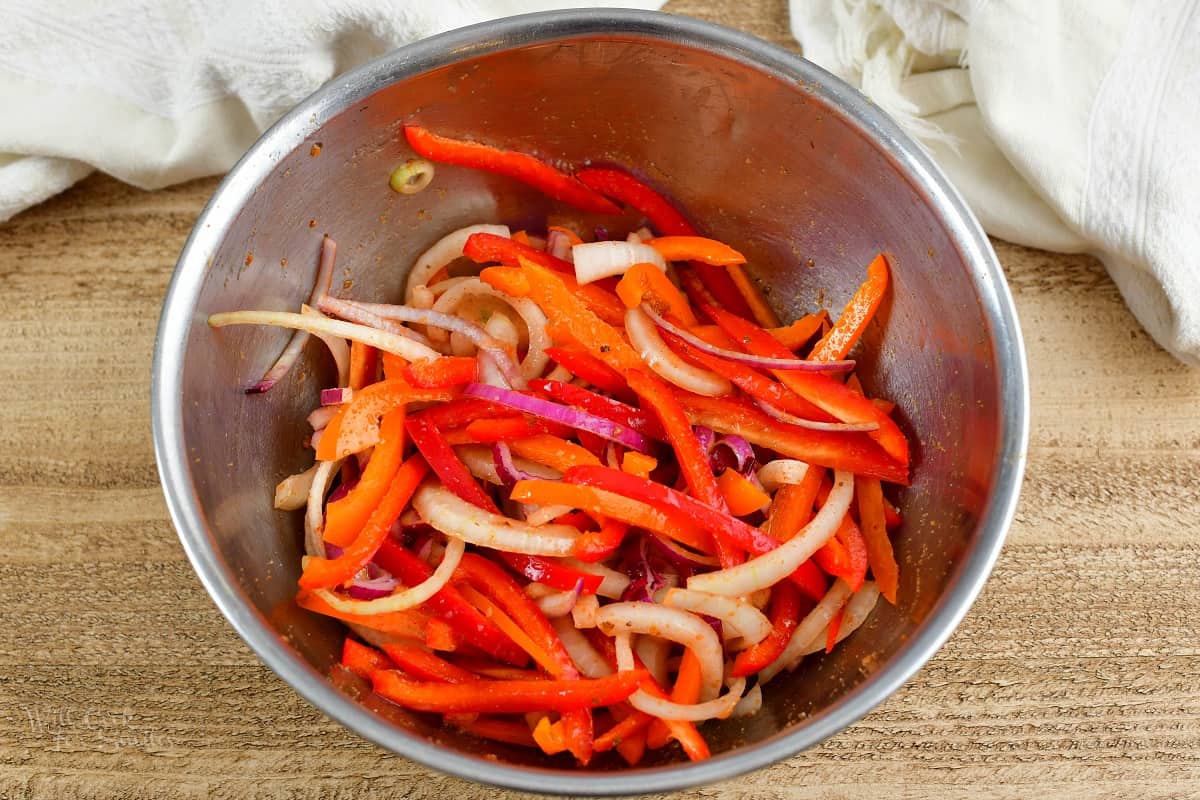 onions and peppers in marinade in a bowl
