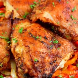 closeup of cooked chicken thighs with peppers