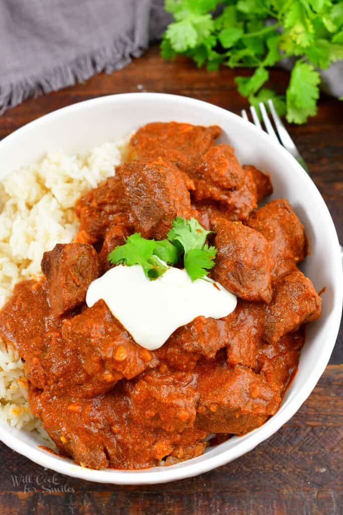 top view of cooked lamb Rogan Josh with rice in a bowl