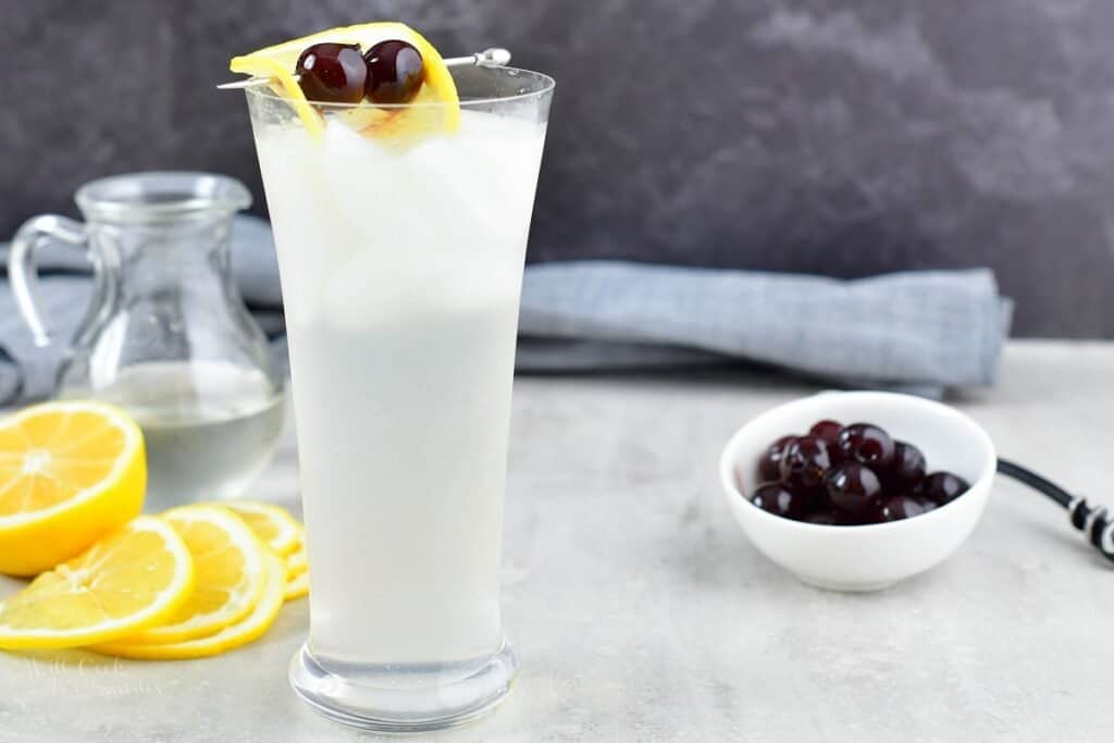 closeup of the tall glass filled with light yellow cocktail