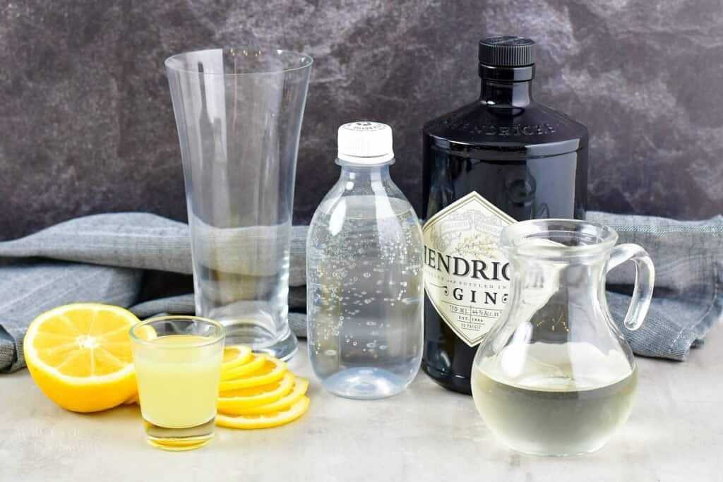 ingredients for Tom Collins cocktail on grey background