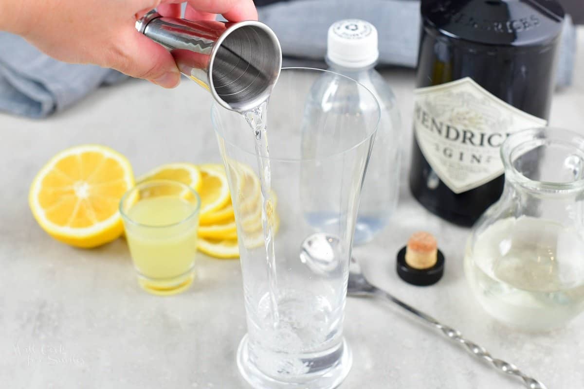 pouring in gin into the tall glass