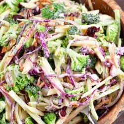 spooning out some broccoli slaw from the bowl