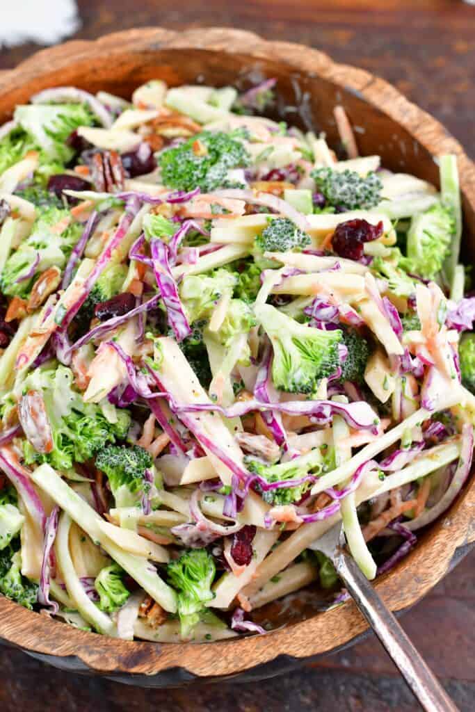 spooning out some broccoli slaw from the bowl