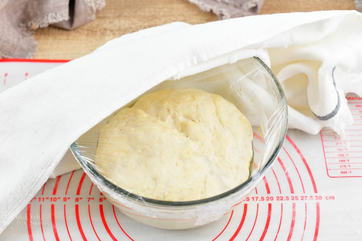 raised dough for the crust in the glass bowl