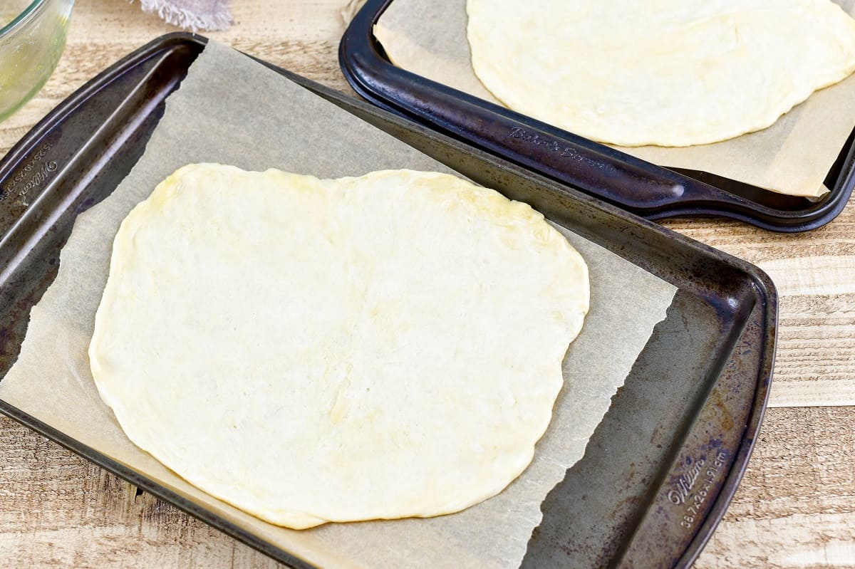 flatbread crust dough on the baking sheet