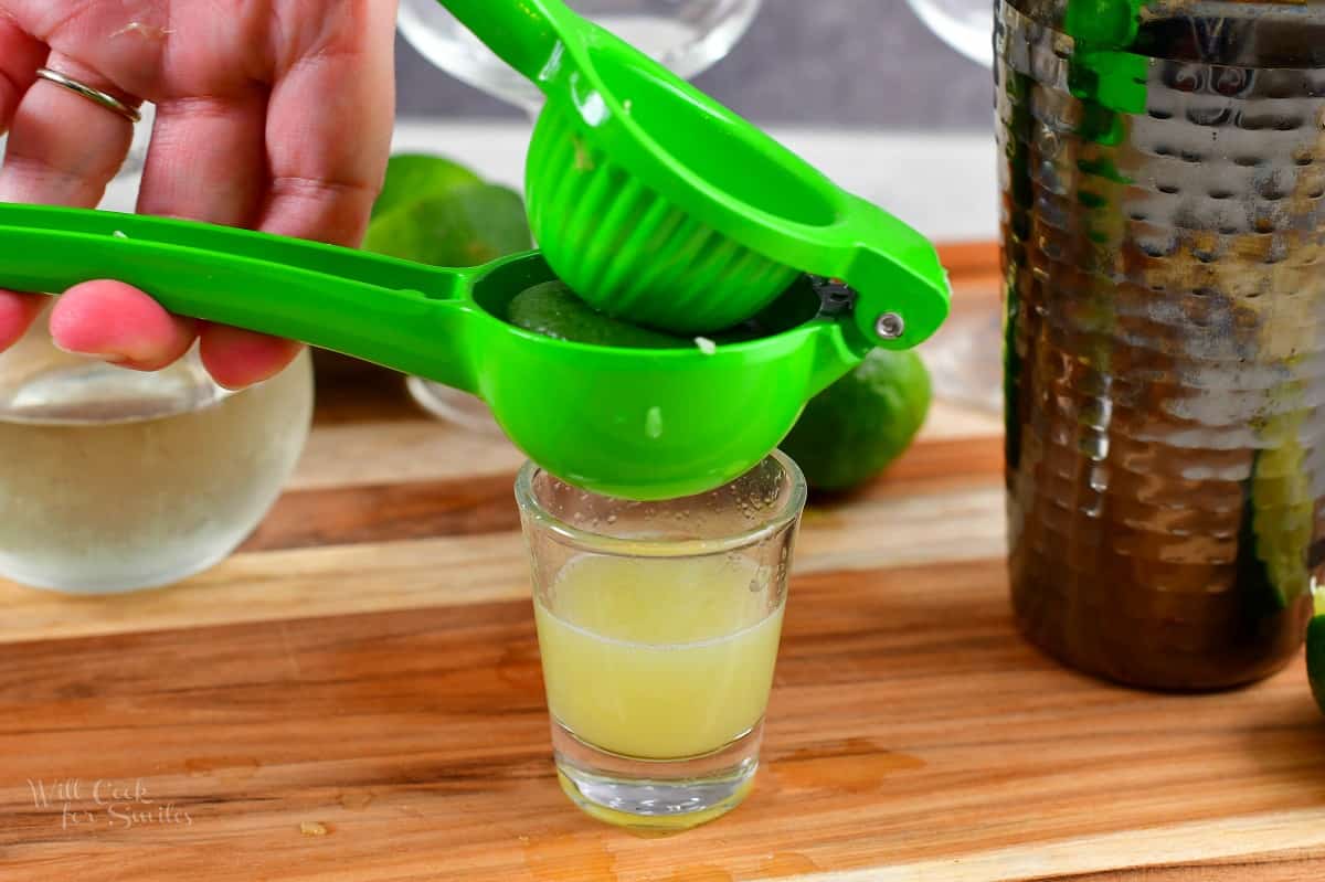 squeezing lime in a lime press