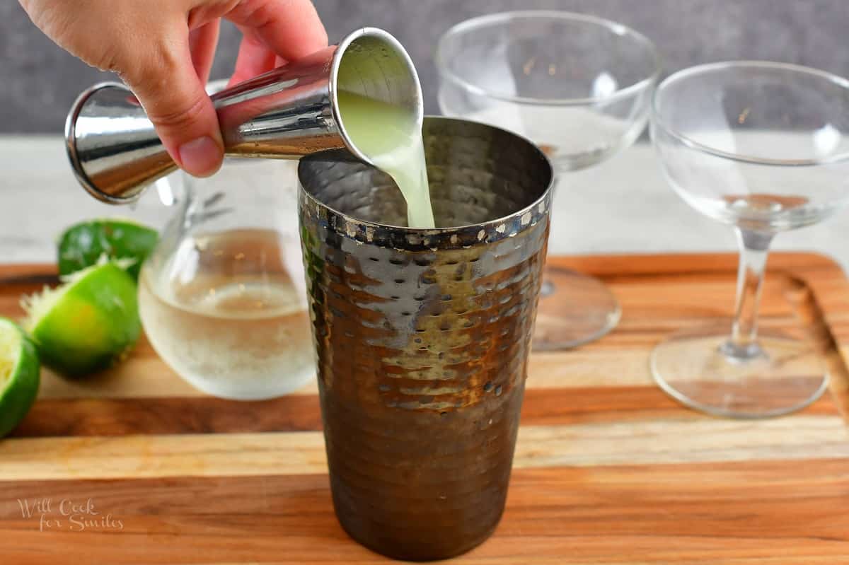 pouring in lime juice into the glass