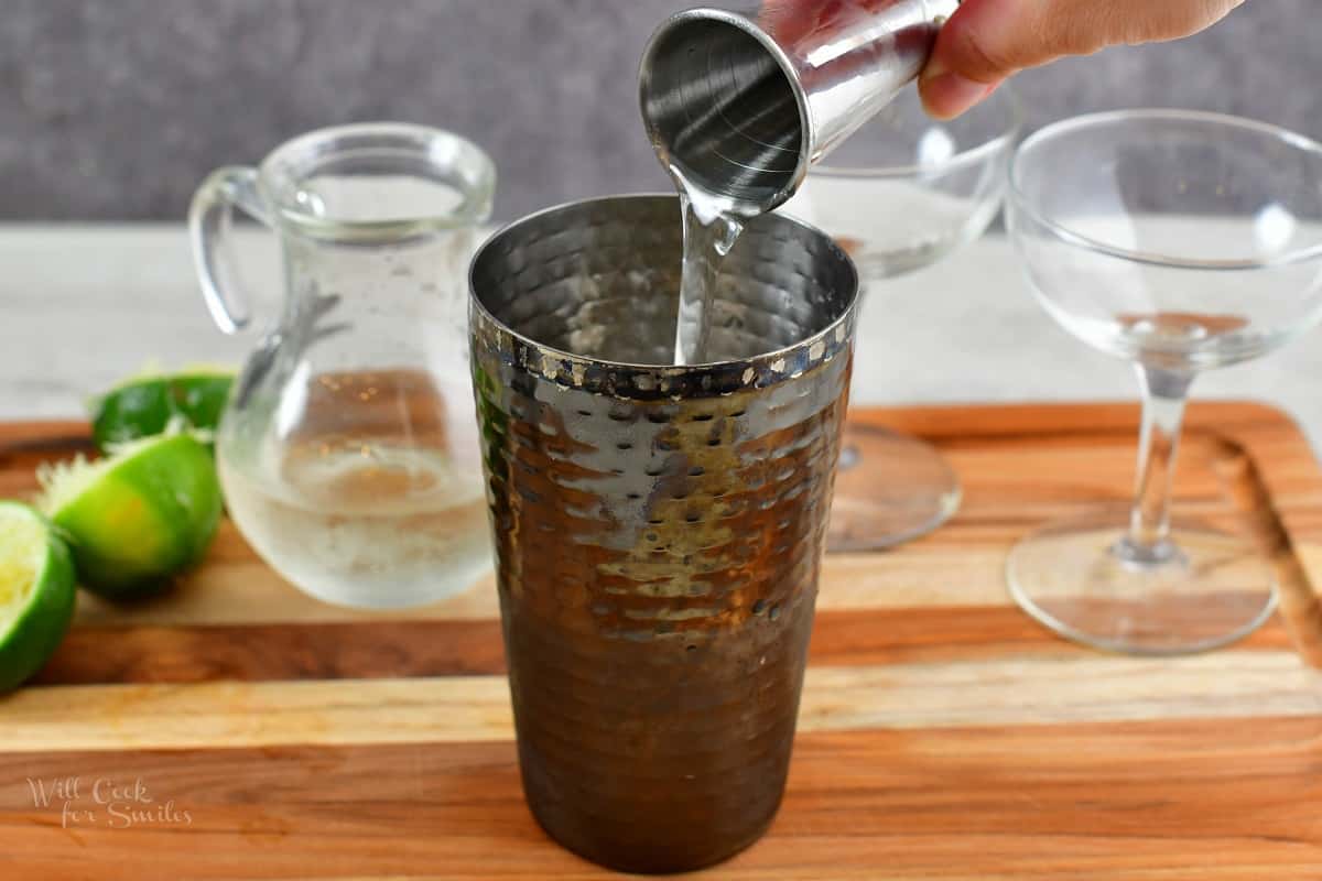 pouring in simple syrup into the glass