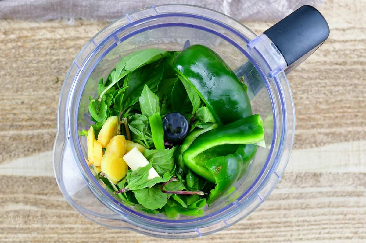 top view of ingredients for the green curry paste in a blender