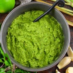 squared off image of green curry in a bowl in the center