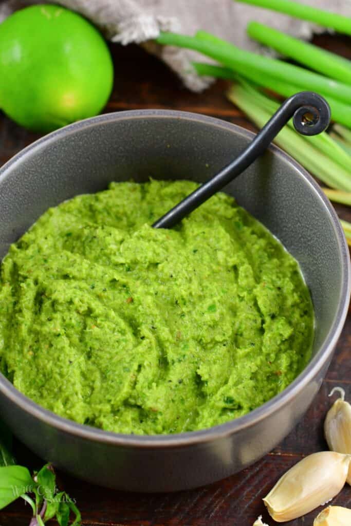 closeup of green curry paste in a bowl with spoon