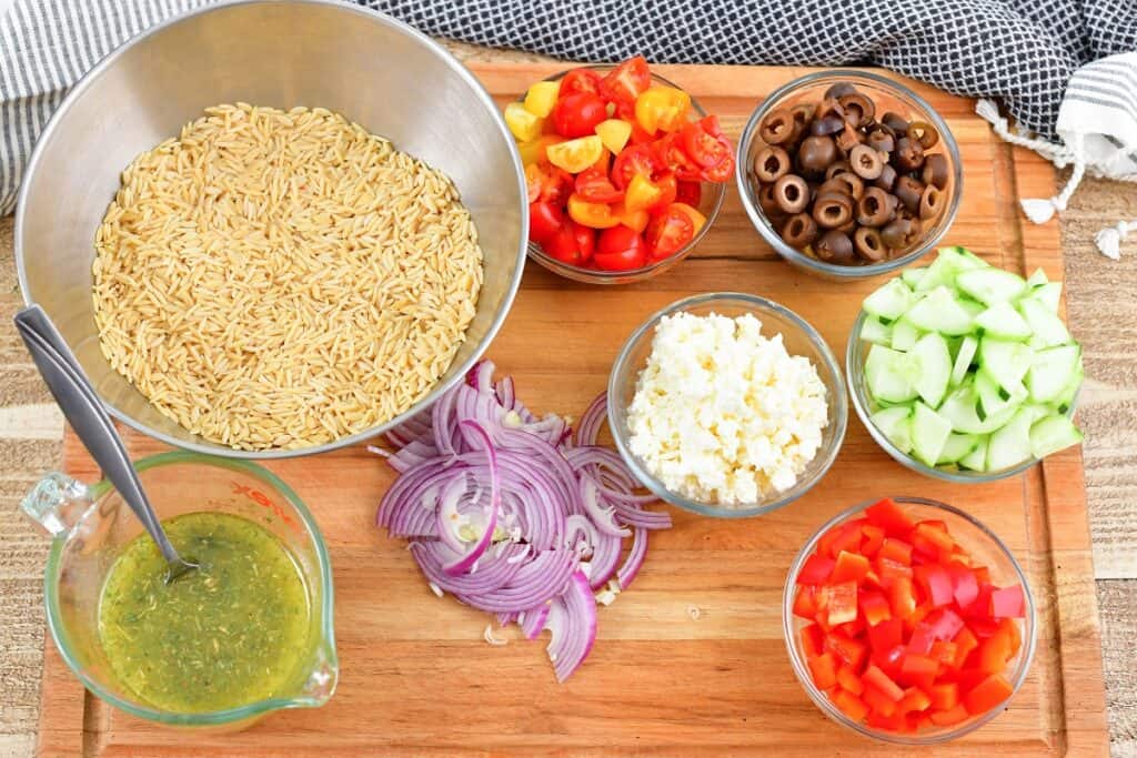 ingredients for orzo salad on the cutting board