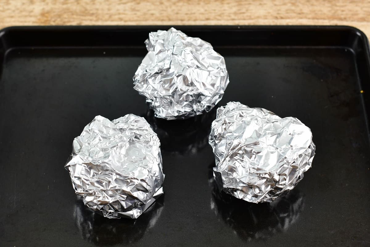 three garlic cloves of baking sheet wrapped in foil