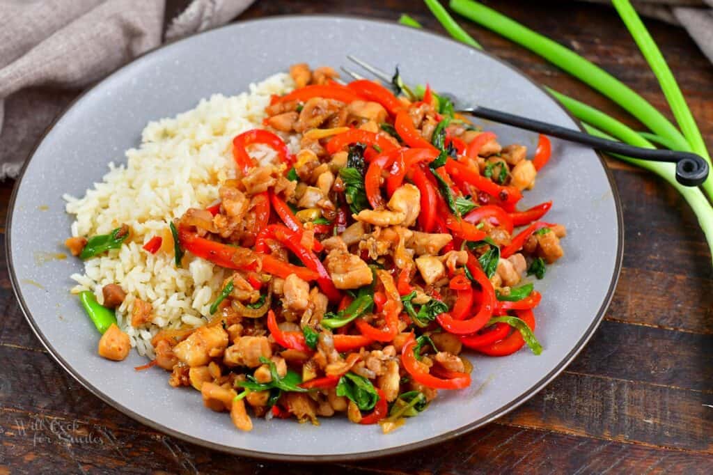 Thai basil chicken with rice and scallions next to it