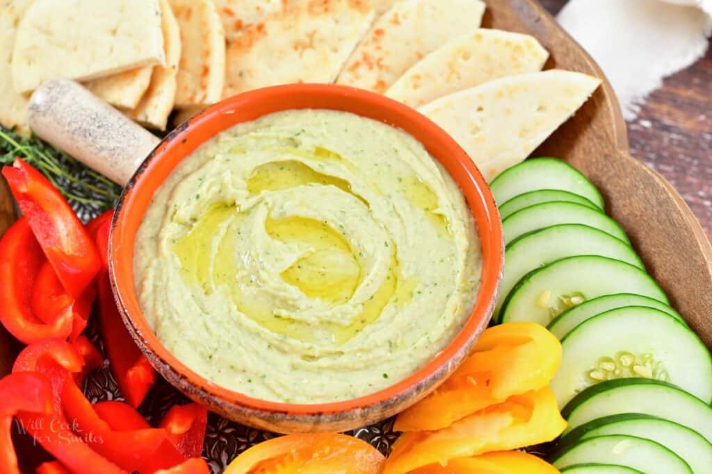 closeup white bean dip with olive oil and vegetables