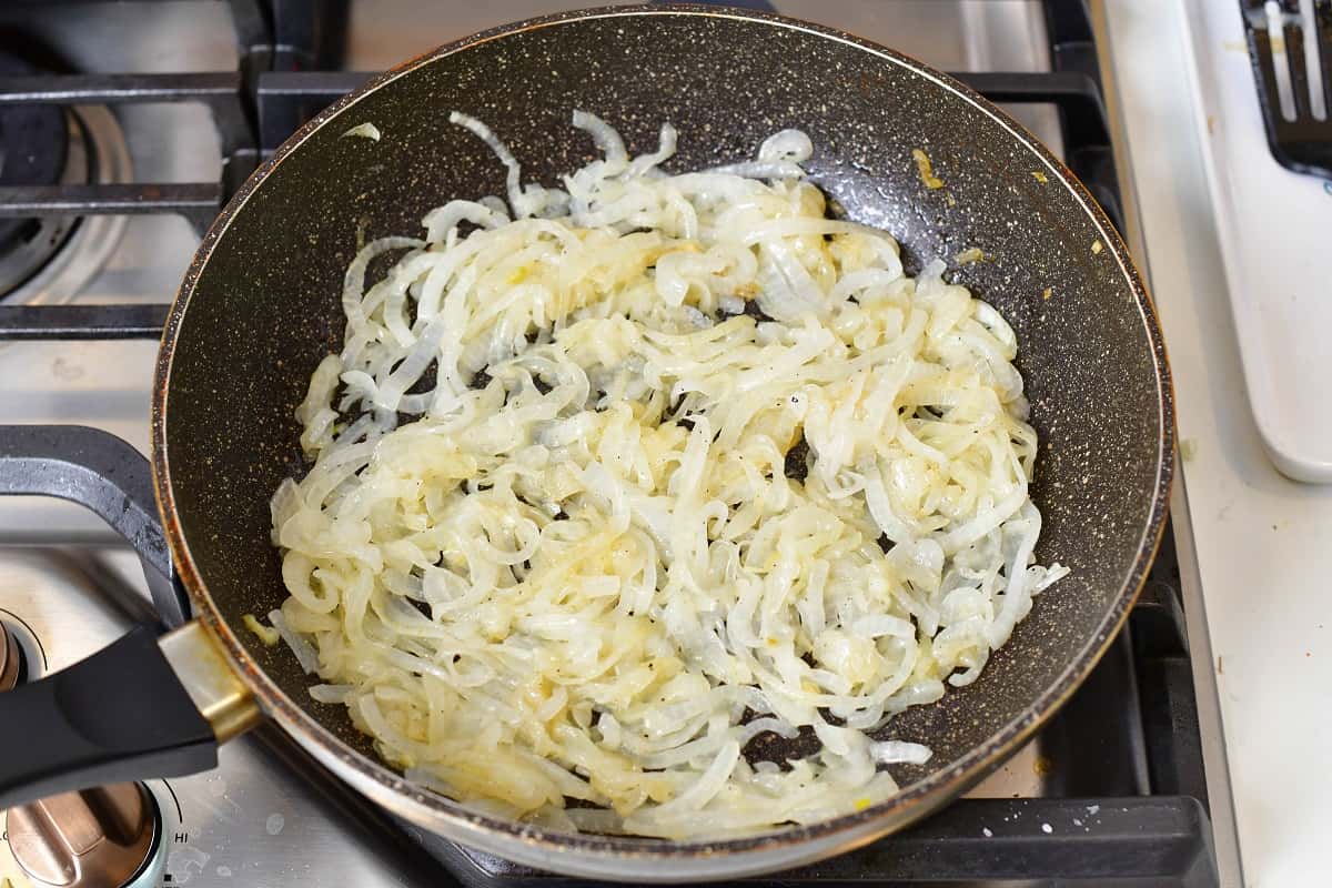 onions starting to cook in a large pan