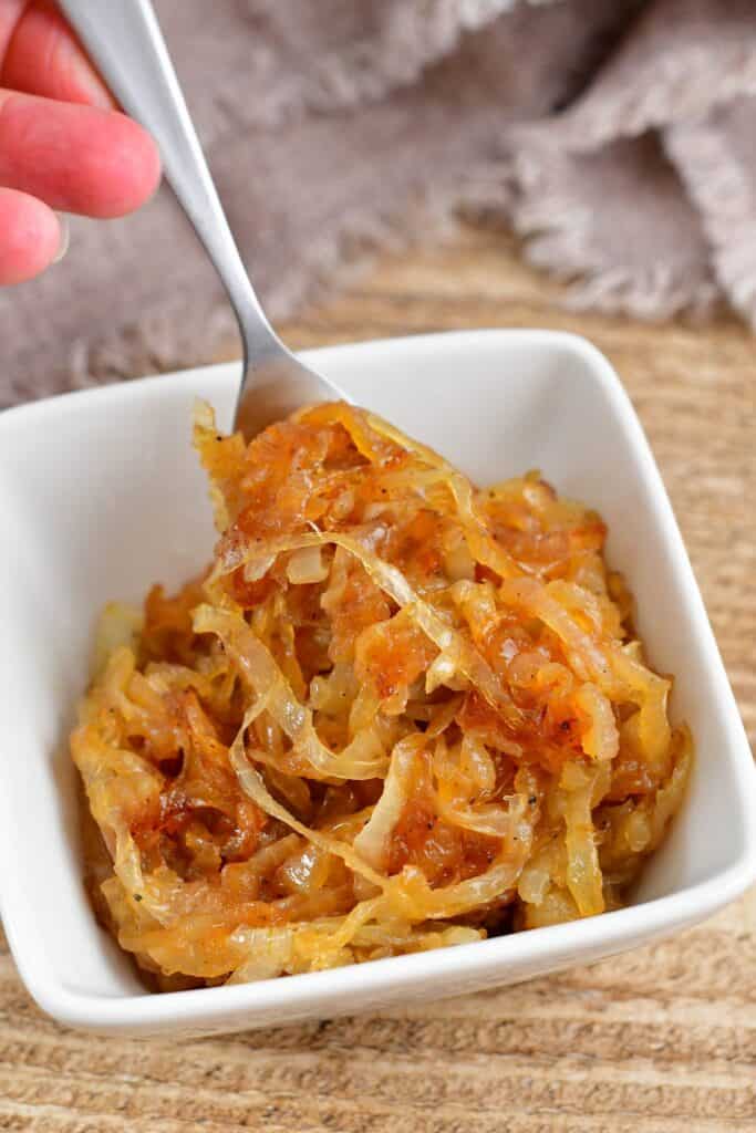 top view of getting caramelized onions out of a bowl